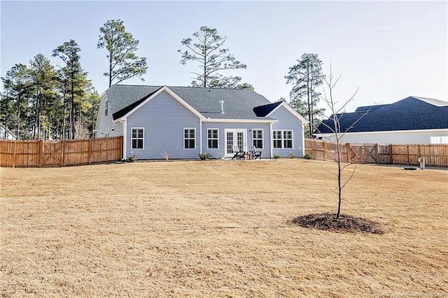 rear view of property with a yard