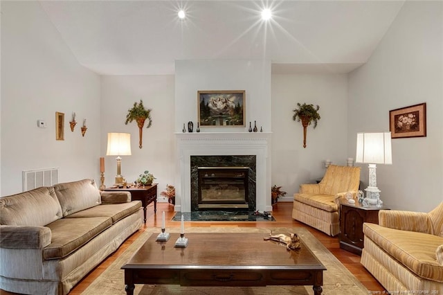 living room featuring a fireplace and light hardwood / wood-style flooring