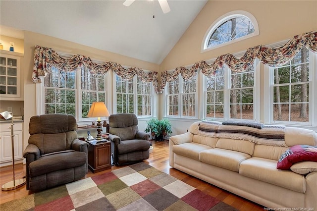 sunroom with ceiling fan and lofted ceiling