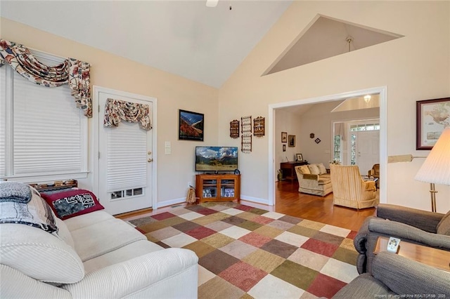 living room featuring high vaulted ceiling and hardwood / wood-style flooring