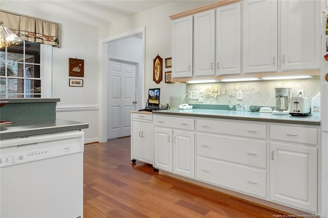 kitchen with white cabinetry, light hardwood / wood-style floors, dishwasher, and tasteful backsplash