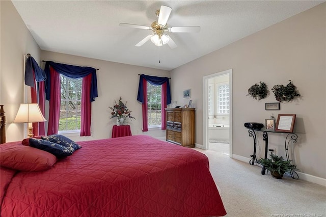 carpeted bedroom featuring ceiling fan and connected bathroom