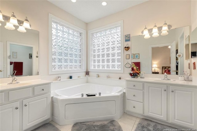 bathroom with a wealth of natural light, tile patterned floors, and vanity