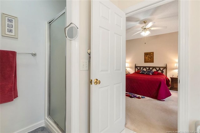 carpeted bedroom with ceiling fan and a textured ceiling