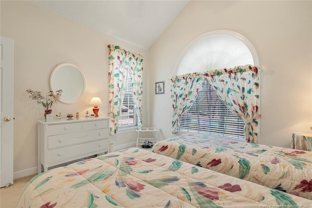 carpeted bedroom featuring lofted ceiling