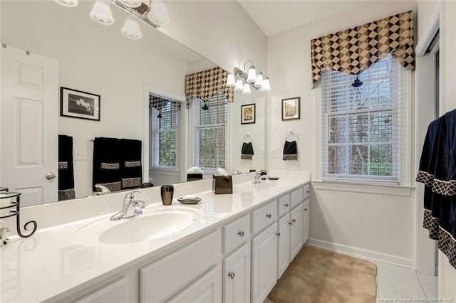 bathroom with vanity, a notable chandelier, and tile patterned flooring