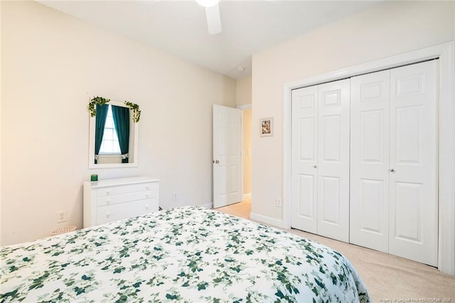 carpeted bedroom featuring ceiling fan and a closet