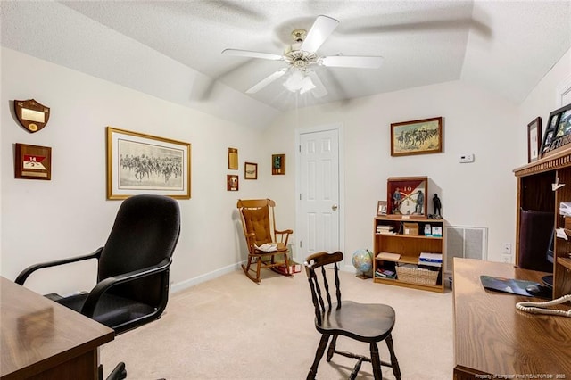 carpeted office space with ceiling fan and vaulted ceiling