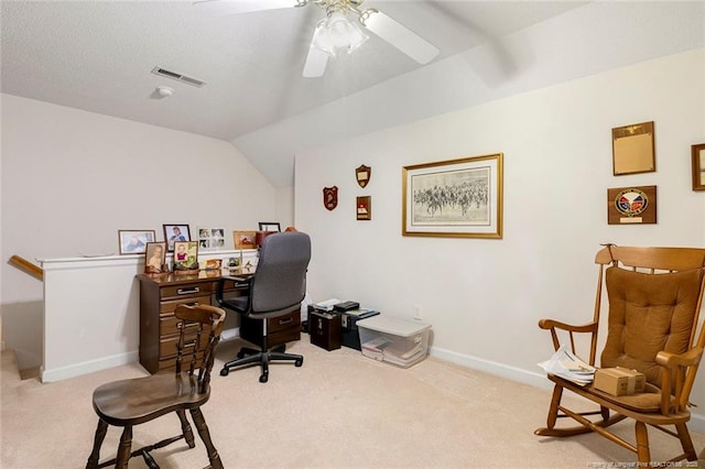 carpeted home office with ceiling fan and vaulted ceiling