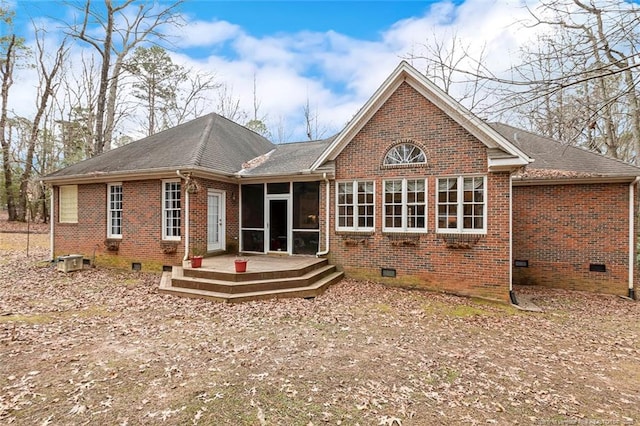 back of property featuring a wooden deck and a sunroom