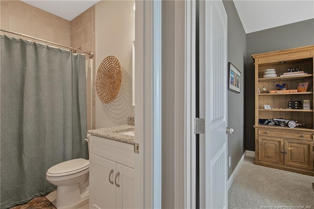 bathroom featuring toilet, vanity, a shower with shower curtain, and vaulted ceiling