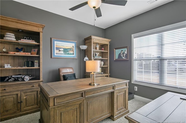 carpeted home office featuring ceiling fan