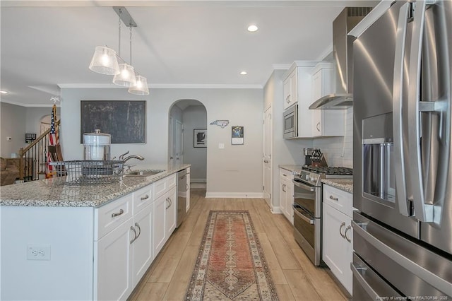 kitchen featuring sink, white cabinets, stainless steel appliances, and an island with sink