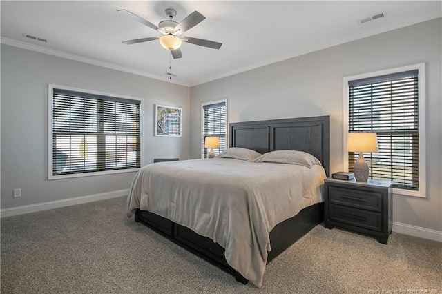 carpeted bedroom with ceiling fan, crown molding, and multiple windows