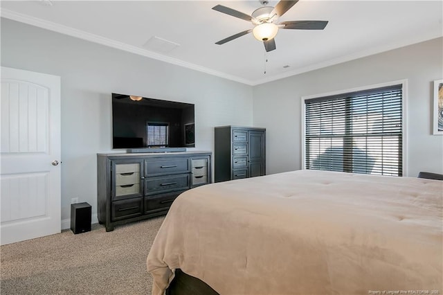 carpeted bedroom featuring ceiling fan and ornamental molding