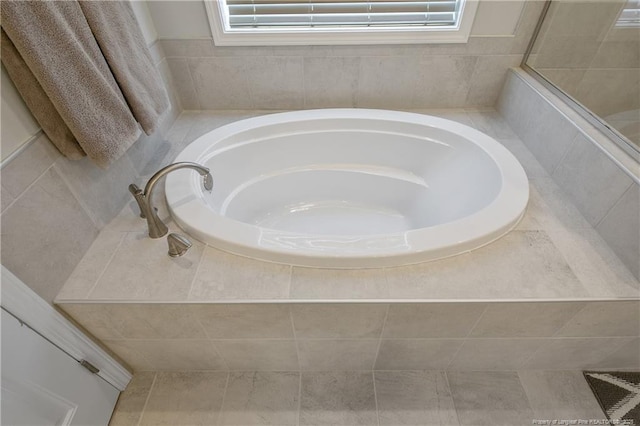 bathroom with tile patterned floors and a washtub