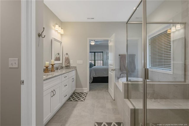 bathroom featuring walk in shower, vanity, tile patterned flooring, and ceiling fan