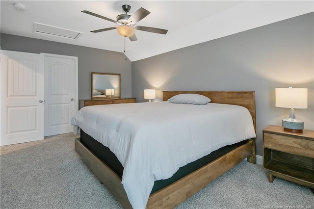 carpeted bedroom featuring ceiling fan, a closet, and vaulted ceiling