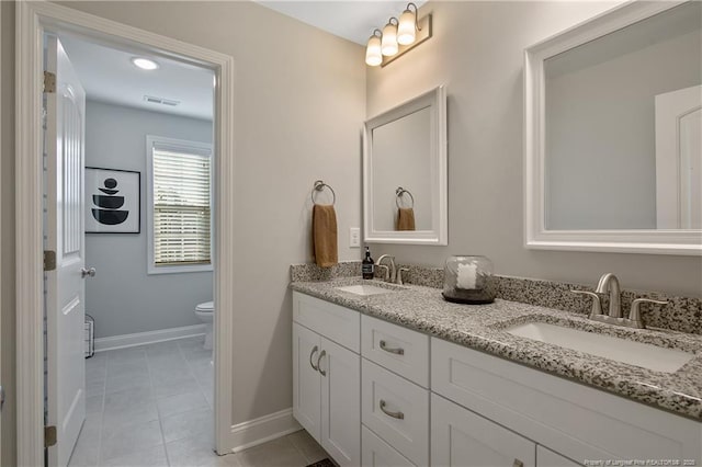 bathroom featuring toilet, vanity, and tile patterned flooring