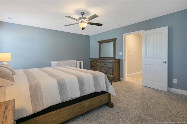 carpeted bedroom featuring ceiling fan and radiator heating unit