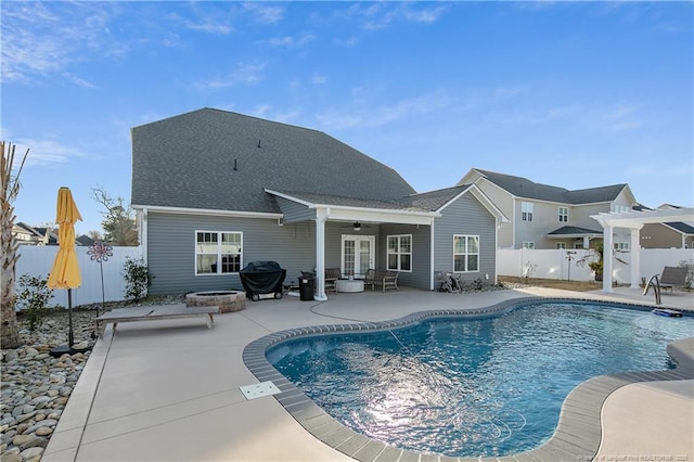 view of swimming pool with a pergola, area for grilling, an outdoor fire pit, and a patio