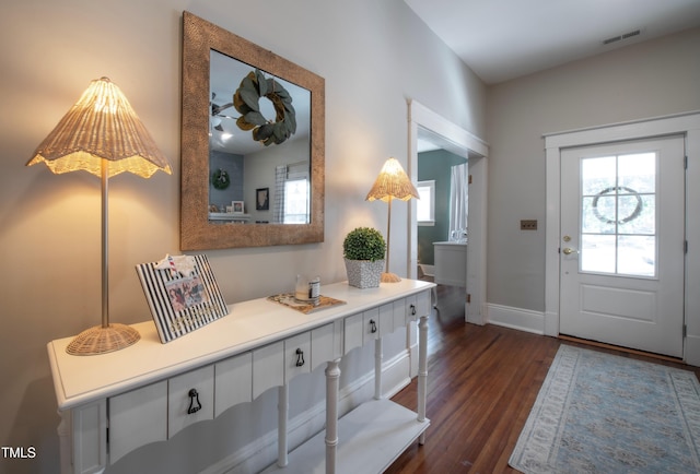 foyer entrance with dark hardwood / wood-style floors