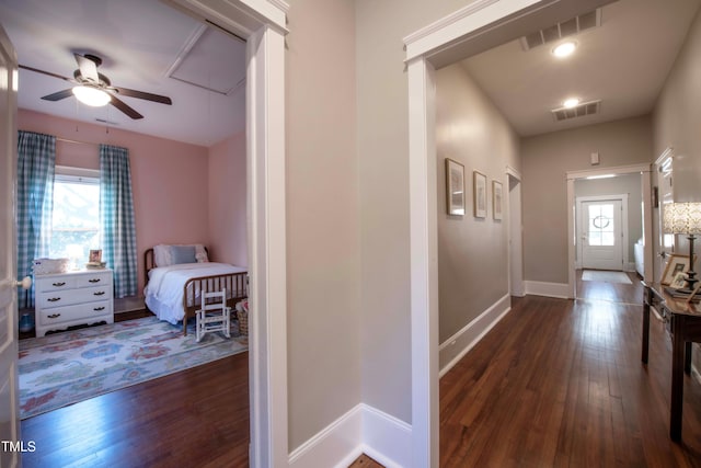 corridor with dark hardwood / wood-style flooring