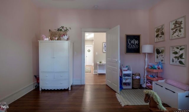 bedroom with dark wood-type flooring