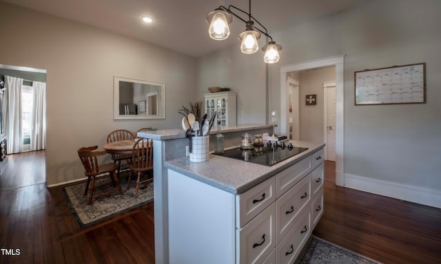 kitchen with pendant lighting, white cabinets, black electric cooktop, and a kitchen island