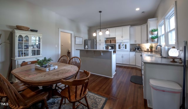 dining room with sink and dark hardwood / wood-style flooring