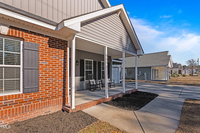 view of exterior entry featuring a porch