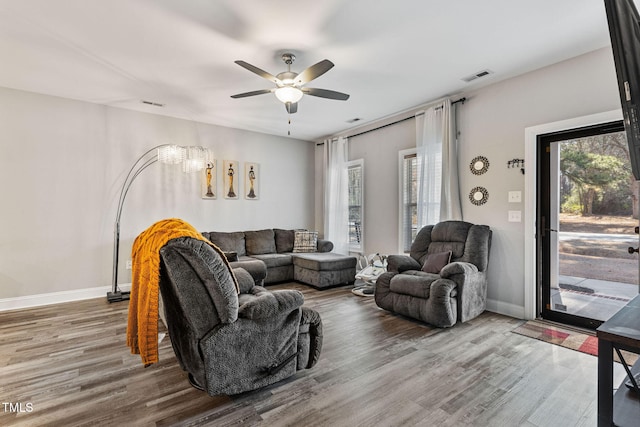 living room with hardwood / wood-style floors and ceiling fan