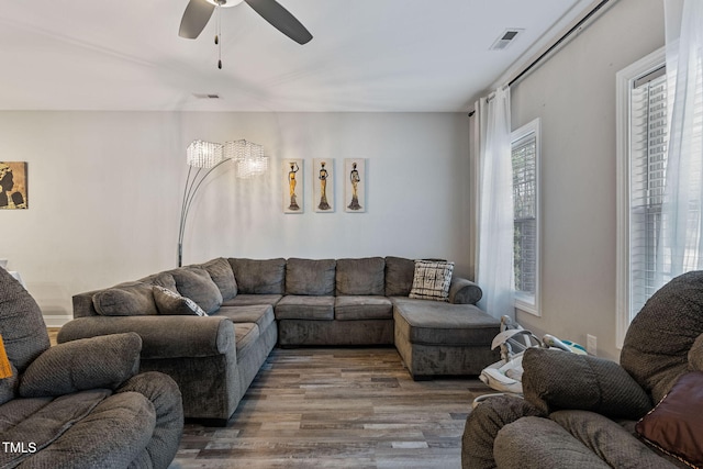 living room with ceiling fan and wood-type flooring