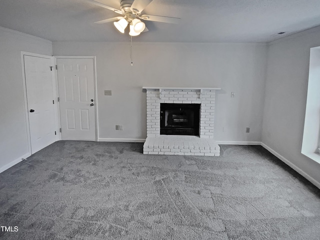 unfurnished living room featuring ceiling fan, a fireplace, and dark carpet