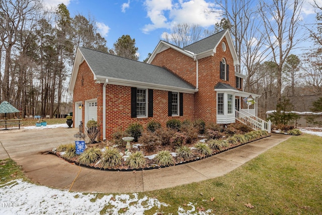 view of side of property with a garage and a yard