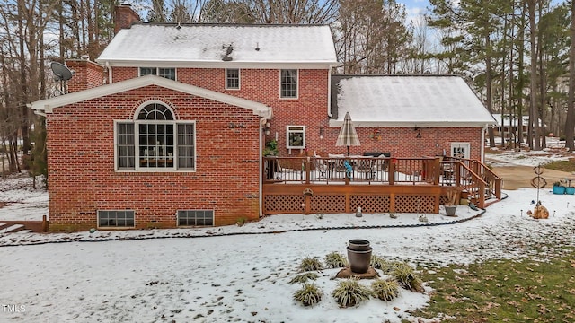 snow covered house with a deck