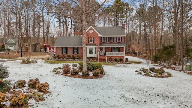 view of front of property featuring a porch and a carport