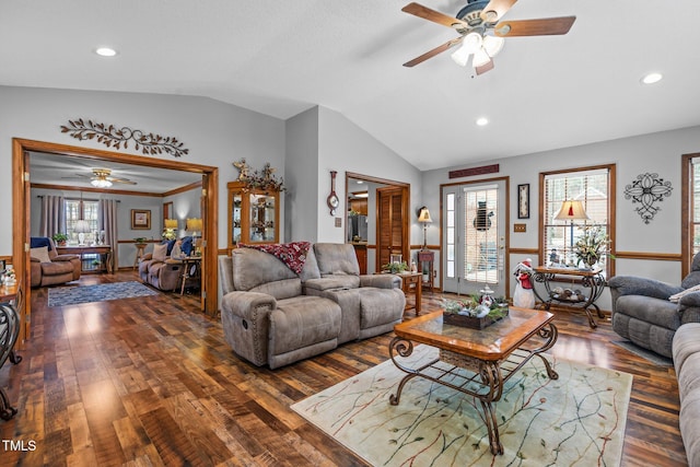 living room with ceiling fan, vaulted ceiling, and dark hardwood / wood-style flooring