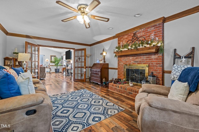 living room featuring french doors, a brick fireplace, crown molding, and hardwood / wood-style flooring