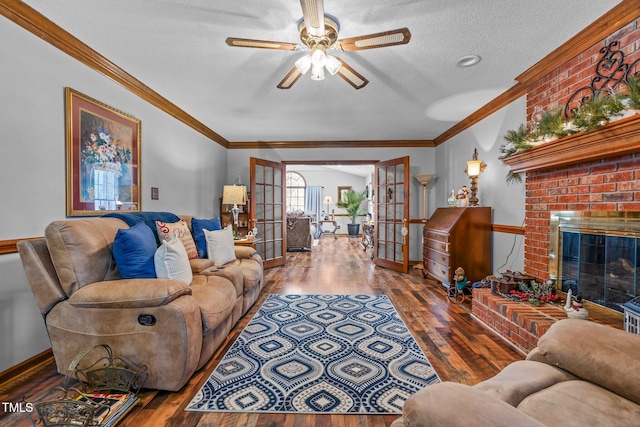 living room with a textured ceiling, hardwood / wood-style floors, a fireplace, and french doors