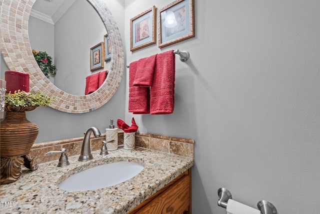 bathroom with vanity and ornamental molding