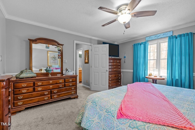 carpeted bedroom with ceiling fan, a textured ceiling, and ornamental molding