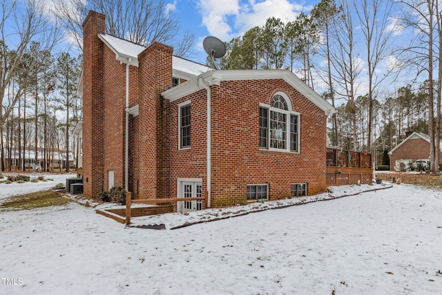 view of snowy exterior with cooling unit