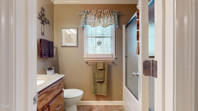 full bathroom with toilet, combined bath / shower with glass door, ornamental molding, and vanity