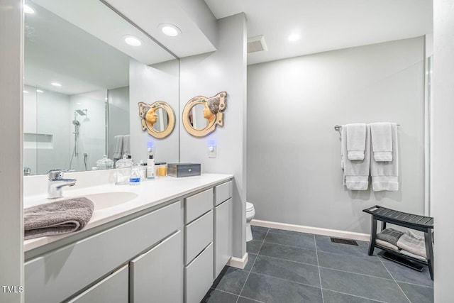 bathroom with vanity, a shower, tile patterned floors, and toilet