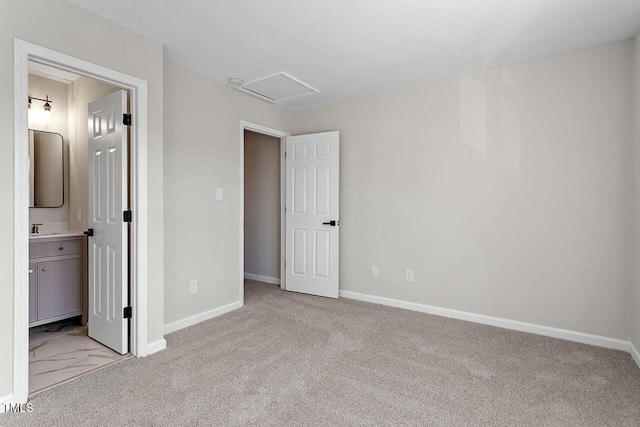 unfurnished bedroom with ensuite bath, light colored carpet, and sink