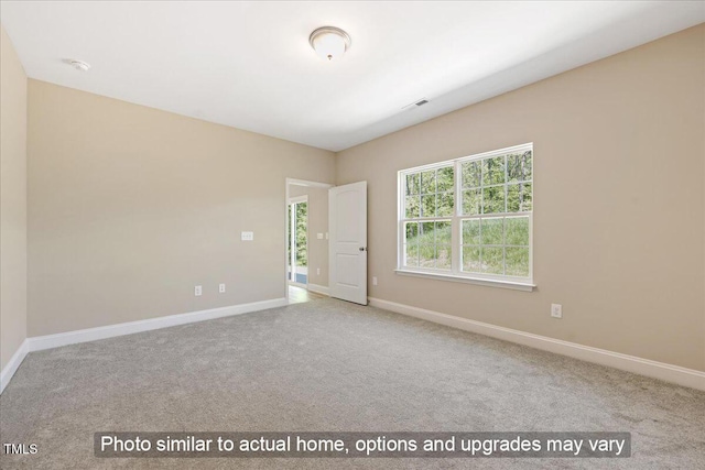 unfurnished room featuring light colored carpet