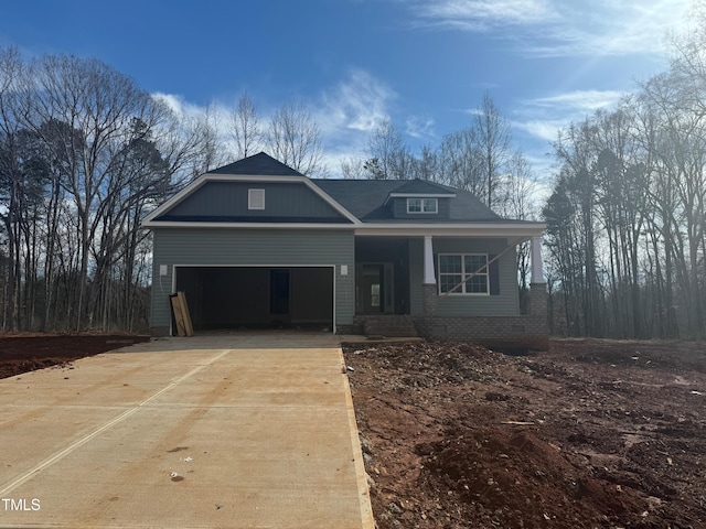 view of front of house featuring a garage and a porch