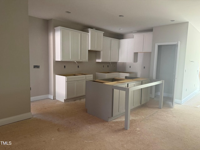 kitchen with white cabinetry and a center island