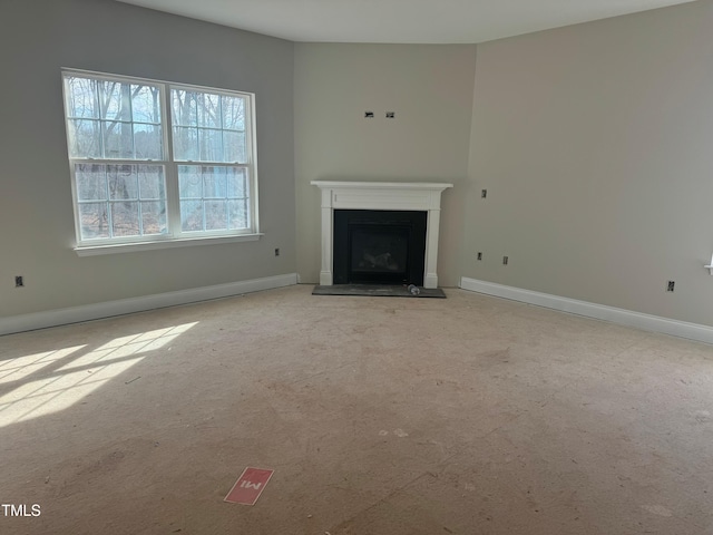 unfurnished living room featuring light carpet